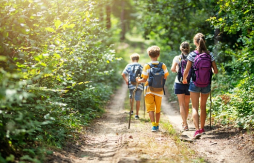Mother and three kids hiking in forest. Family is having great time together.
Nikon D850