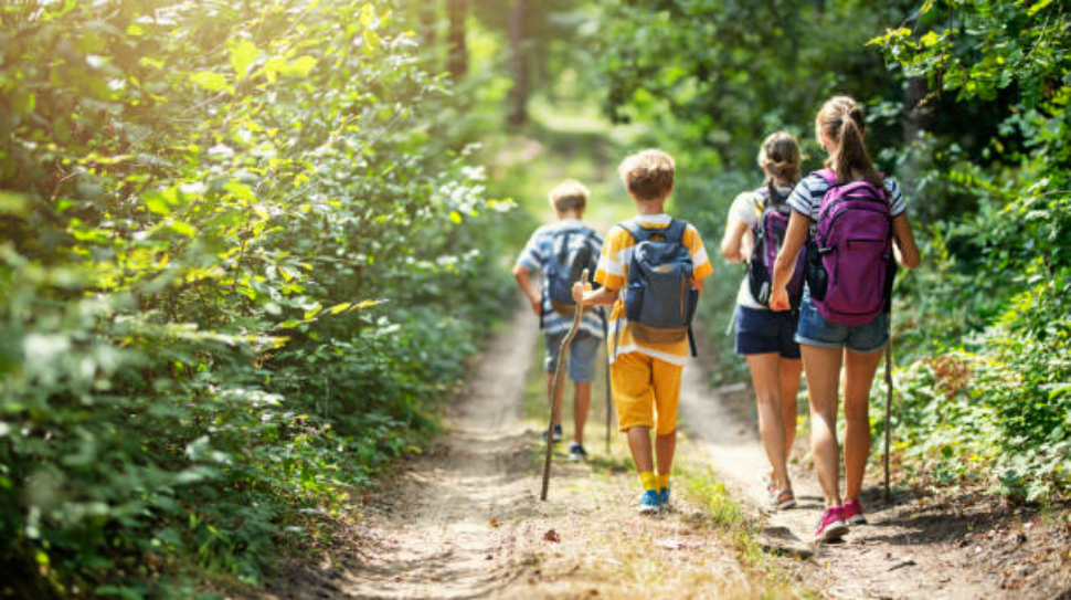 Mother and three kids hiking in forest. Family is having great time together.
Nikon D850